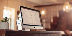 AI virtual receptionist software on computer and smartphone.